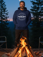 Load image into Gallery viewer, Man wearing a hoodie with a Beers and Bonfires design by a campfire at night.
